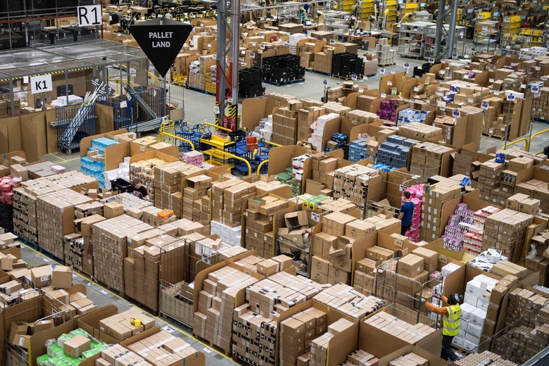 Workers prepare customer orders for dispatch as they work around goods stored inside an Amazon.co.uk fulfillment centre in Peterborough, central England, on November 15, 2017.
Shops could be seeing the effect of consumers postponing purchases until 'Black Friday' on November 24, 2017, a day of sales in the United States that has become increasingly popular in Britain. / AFP PHOTO / CHRIS J RATCLIFFE (Photo credit should read CHRIS J RATCLIFFE/AFP/Getty Images)